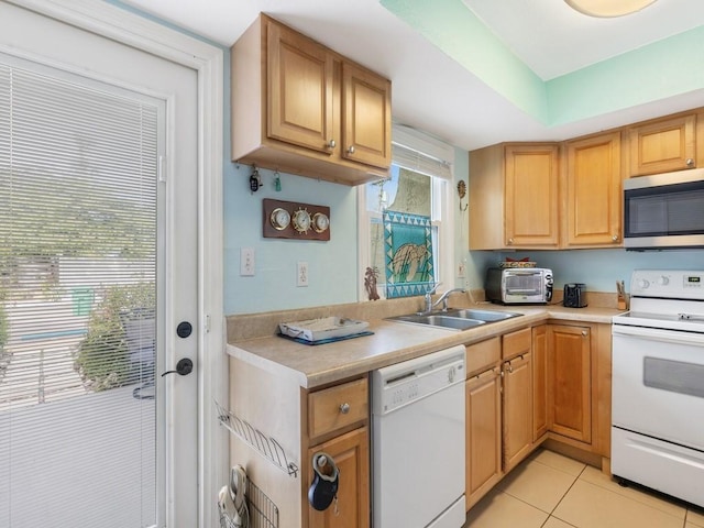 kitchen with light tile patterned floors, sink, and white appliances