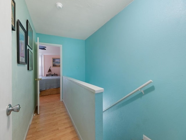 hallway with light hardwood / wood-style floors