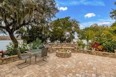 view of patio / terrace with a water view and an outdoor fire pit