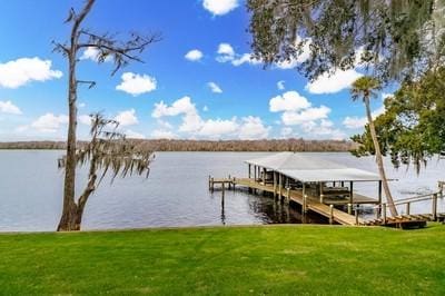 dock area featuring a water view and a yard