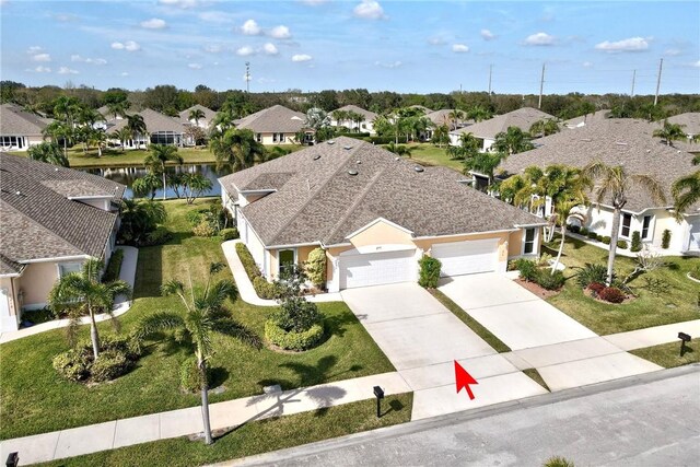 ranch-style home featuring a garage and a front yard