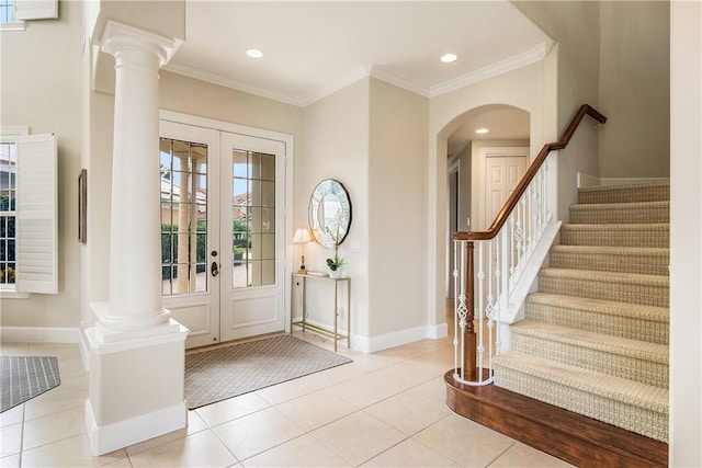 foyer entrance with light tile patterned floors, french doors, and ornamental molding