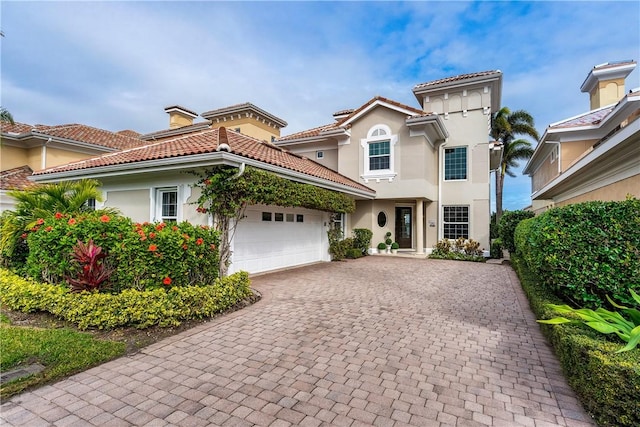 mediterranean / spanish-style home with a garage