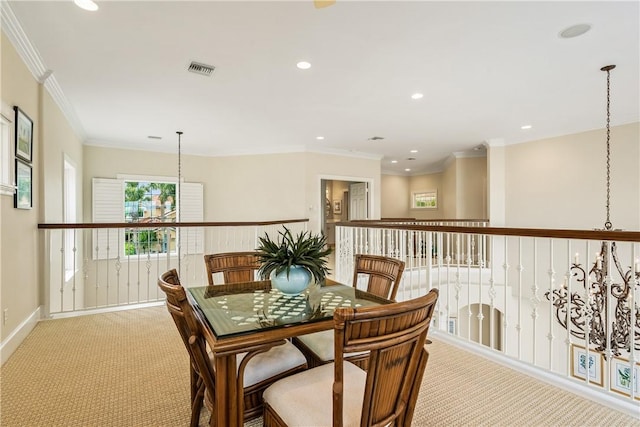 dining space featuring light carpet and crown molding