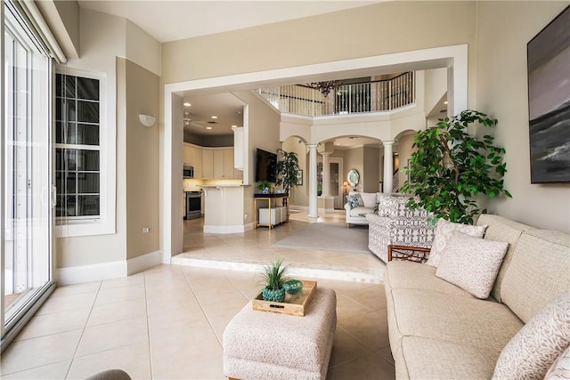 tiled living room featuring decorative columns