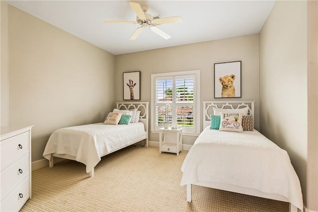 bedroom with ceiling fan and light carpet