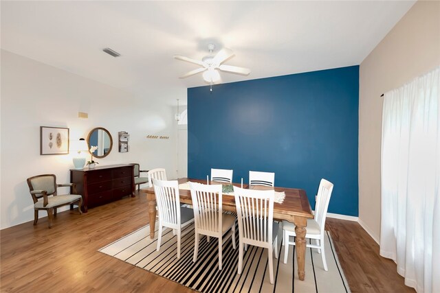 dining space with hardwood / wood-style flooring and ceiling fan