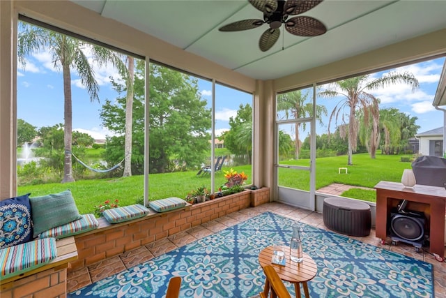 sunroom / solarium featuring a wealth of natural light and ceiling fan