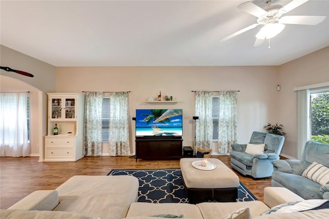 living room featuring wood-type flooring and ceiling fan