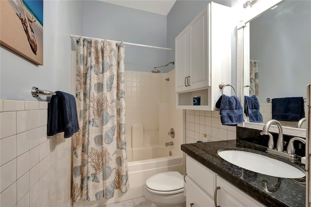 full bathroom with tile walls, vanity, tile patterned floors, toilet, and shower / bath combo with shower curtain