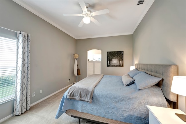 bedroom with ceiling fan, light colored carpet, ornamental molding, and multiple windows