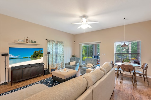 living room with wood-type flooring and ceiling fan