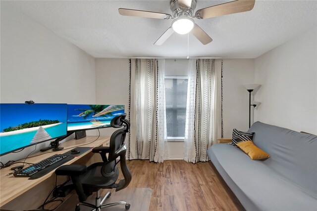 office featuring ceiling fan, wood-type flooring, and a textured ceiling