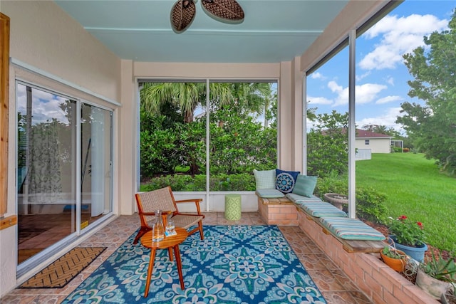 sunroom / solarium featuring ceiling fan