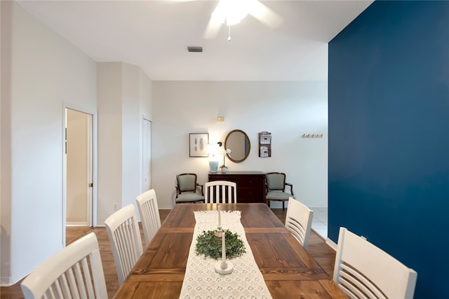 dining space with hardwood / wood-style flooring and ceiling fan