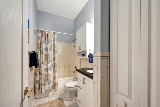 full bathroom featuring shower / tub combo with curtain, tile patterned floors, toilet, tile walls, and vanity