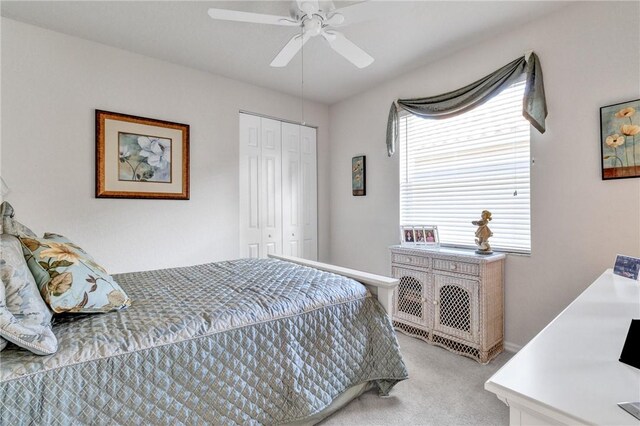 carpeted bedroom with a closet and ceiling fan