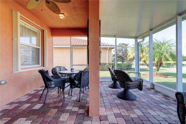 sunroom featuring ceiling fan