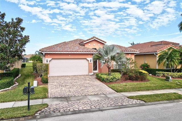 mediterranean / spanish-style house with a garage and a front lawn