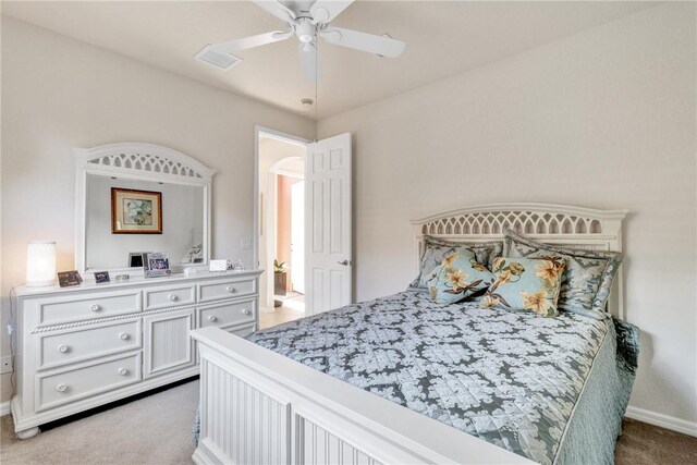 bedroom with ceiling fan and light colored carpet