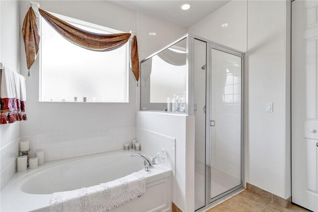 bathroom with tile patterned floors and independent shower and bath