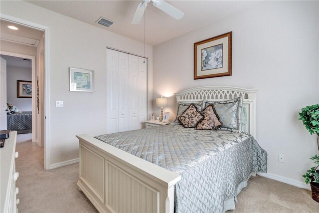 carpeted bedroom featuring ceiling fan and a closet