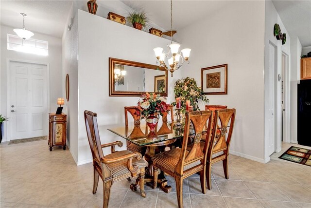 dining area with light tile patterned floors, a notable chandelier, and a high ceiling