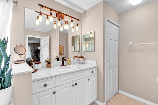 bathroom featuring tile patterned floors, vanity, and a textured ceiling