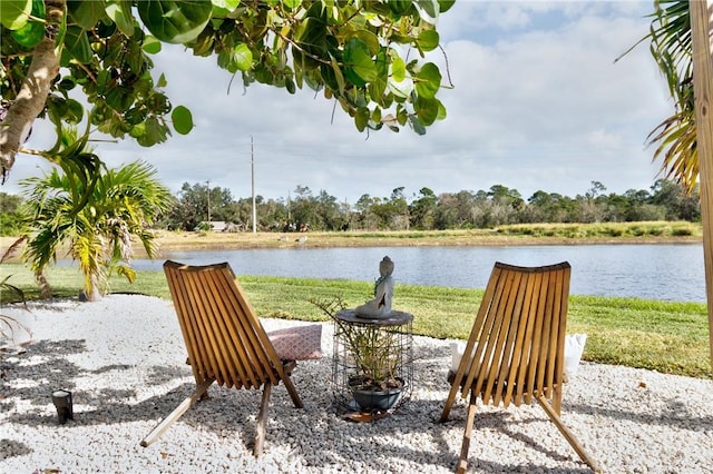 exterior space featuring a water view and a lawn