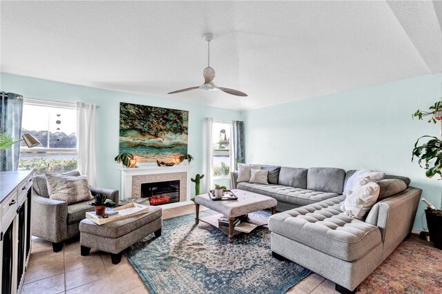 living room featuring ceiling fan and light tile patterned floors