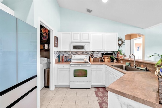 kitchen featuring white cabinets, lofted ceiling, white appliances, and sink