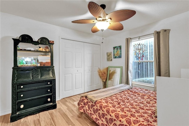 bedroom featuring ceiling fan, light hardwood / wood-style floors, and a closet