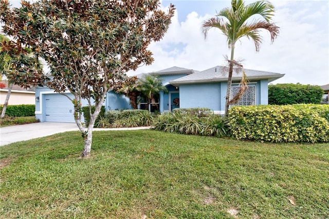 obstructed view of property featuring a garage and a front lawn