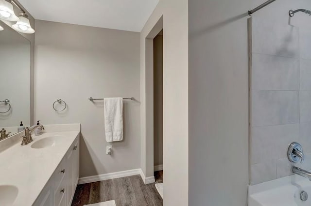 5060 Harmony Cir Unit 307, Vero Beach, FL 32967 - full bath featuring wood finished floors,  shower combination, double vanity, and baseboards