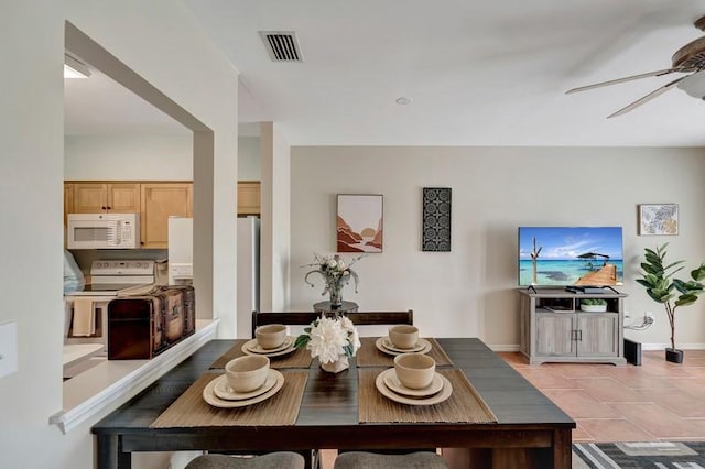 5060 Harmony Cir Unit 307, Vero Beach, FL 32967 - dining space featuring a ceiling fan, baseboards, and light tile patterned flooring