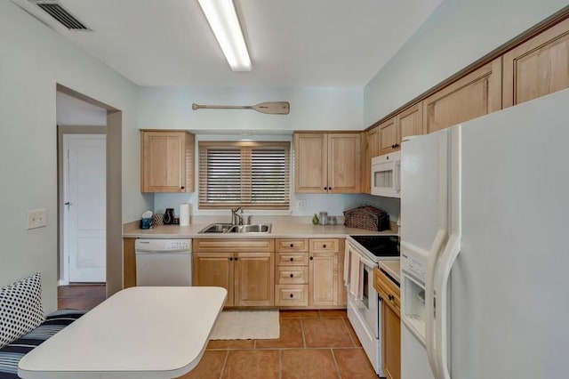 5060 Harmony Cir Unit 307, Vero Beach, FL 32967 - kitchen with white appliances, a sink, light countertops, light brown cabinets, and light tile patterned floors