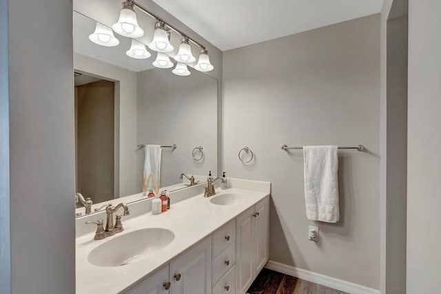 5060 Harmony Cir Unit 307, Vero Beach, FL 32967 - bathroom featuring double vanity, baseboards, and wood finished floors