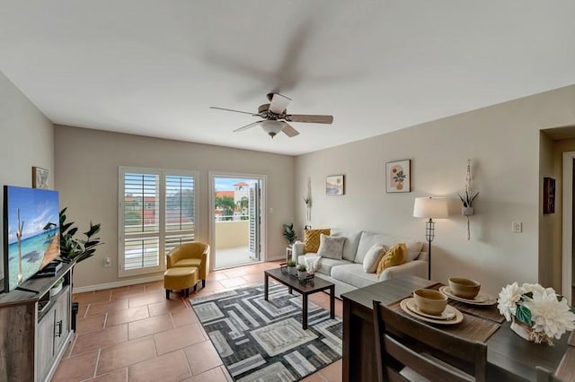 5060 Harmony Cir Unit 307, Vero Beach, FL 32967 - living room with ceiling fan, baseboards, and light tile patterned floors
