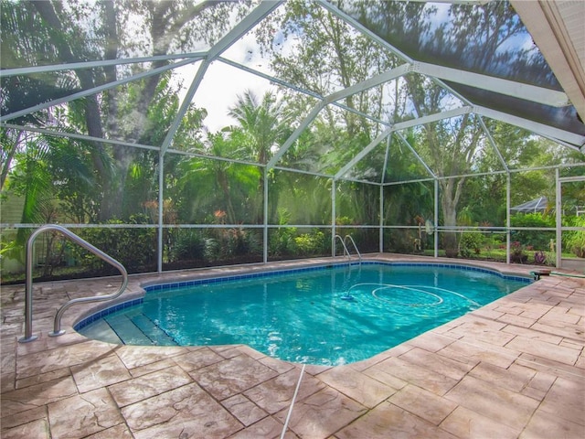 view of pool with a lanai and a patio area