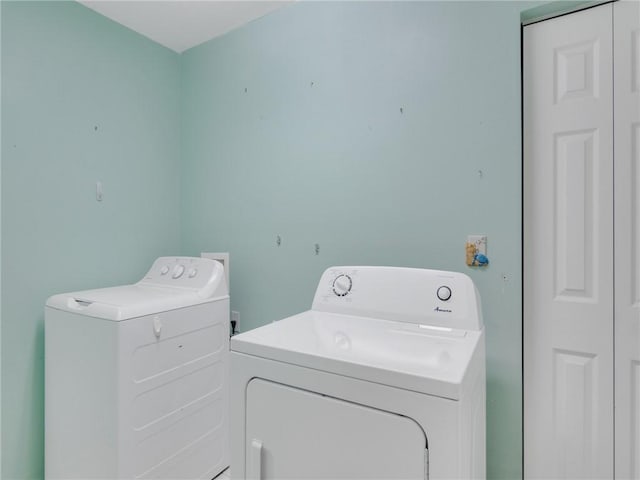 clothes washing area with independent washer and dryer