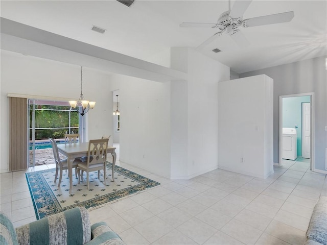 tiled dining room featuring ceiling fan with notable chandelier, washer / clothes dryer, and vaulted ceiling