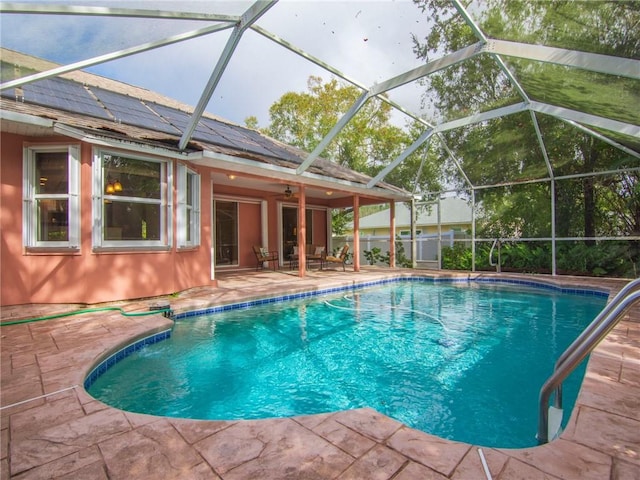 view of swimming pool with a lanai and a patio area