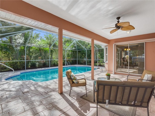 view of swimming pool featuring ceiling fan, an outdoor hangout area, a patio, and glass enclosure