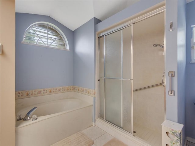 bathroom with tile patterned floors, separate shower and tub, and lofted ceiling