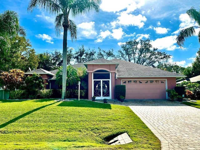 ranch-style home with a garage and a front lawn