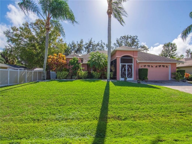 view of front of property with a front yard and a garage