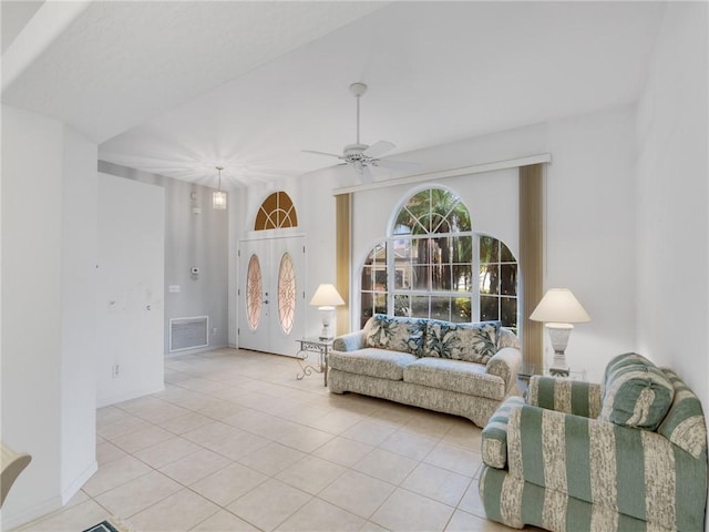 living room with french doors, light tile patterned floors, and ceiling fan