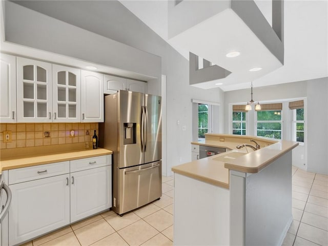 kitchen with white cabinetry, sink, stainless steel appliances, decorative backsplash, and light tile patterned floors