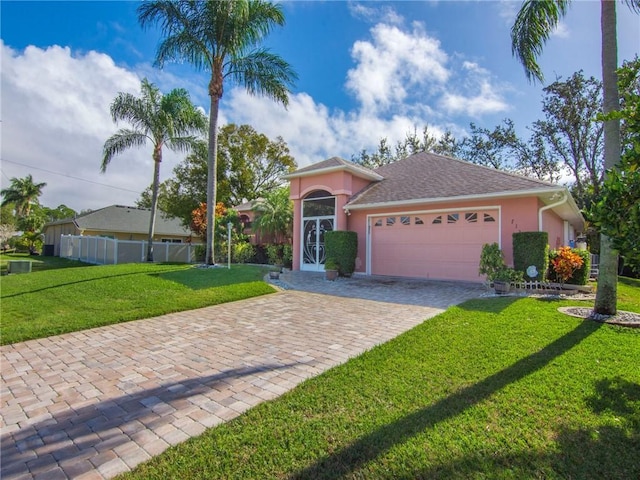 ranch-style house featuring a front lawn and a garage