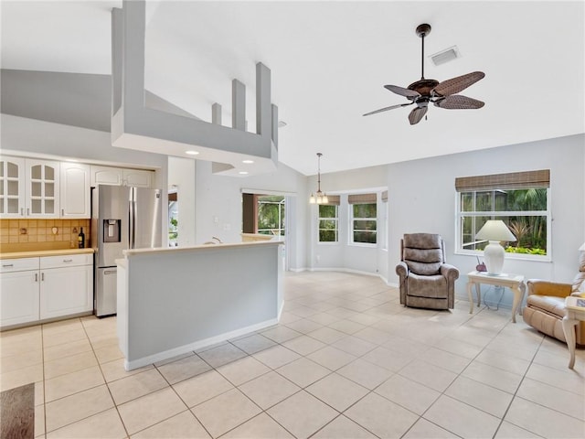 kitchen featuring ceiling fan, white cabinetry, stainless steel refrigerator with ice dispenser, and light tile patterned floors